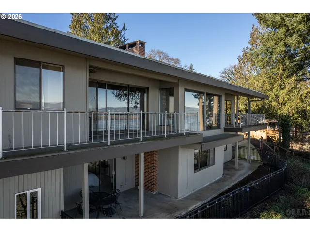 a view of a house with a wooden deck