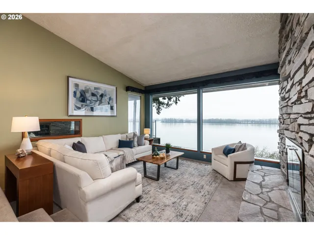a living room with furniture and floor to ceiling window