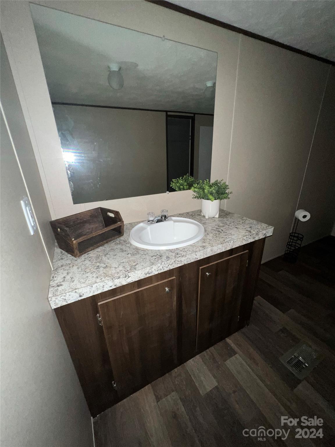 133 Calhoun Road, Unit 2 Stony Point, NC 28678 - Photo 21 of 24 a bathroom with a granite countertop sink and a mirror