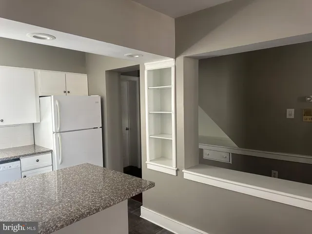 a kitchen with a refrigerator and countertop