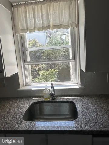 a kitchen with a sink and a window