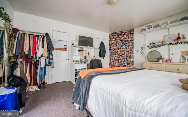 a bedroom with a bed and a large mirror