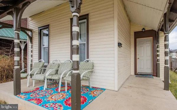 a front view of house with deck and outdoor seating
