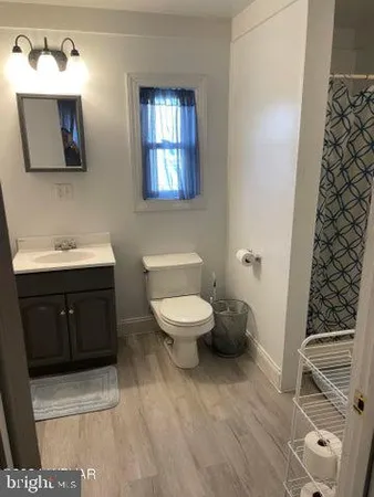 a bathroom with a toilet a sink and mirror