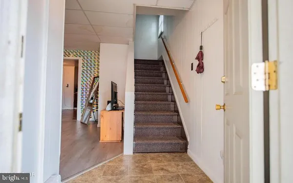 a view of a hallway with wooden floor and stairs