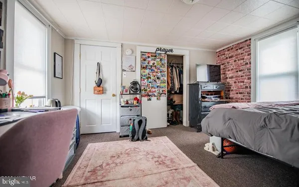 a bedroom with a bed and dresser