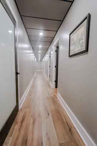 a view of hallway with wooden floor