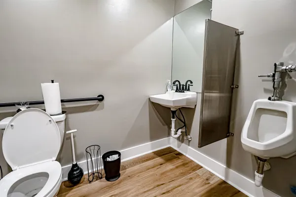a bathroom with a sink a toilet and a mirror