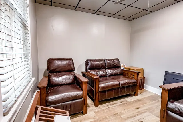 a living room with furniture a couch and a window