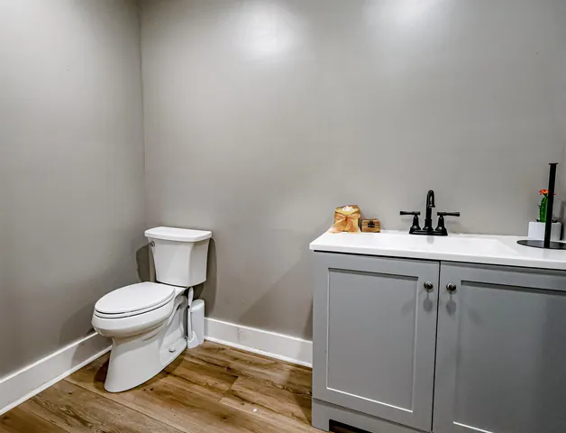 a white toilet sitting next to a bathroom sink