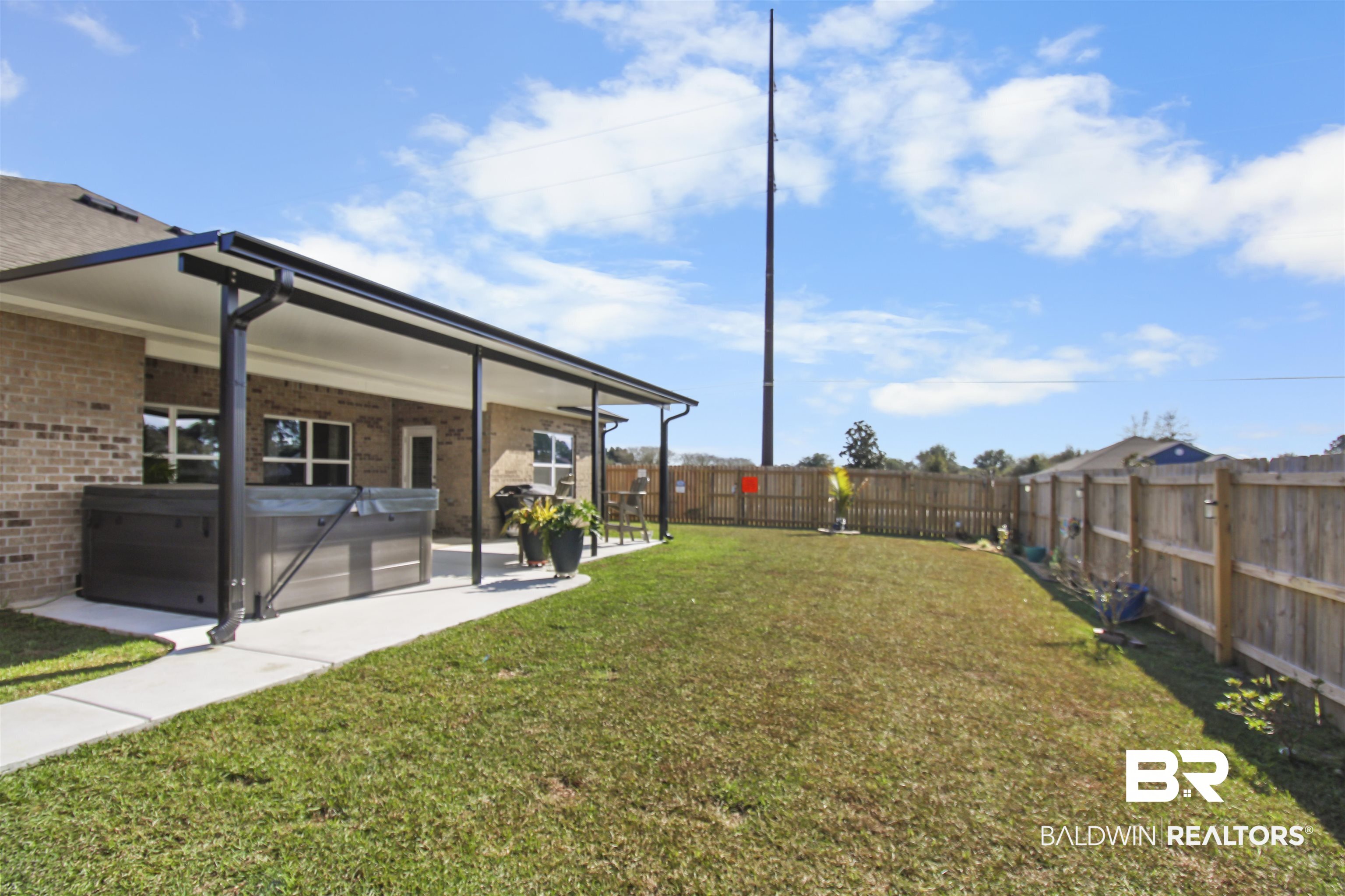 12523 Pheasant Run Elberta, AL 36530 - Photo 35 of 43 Fenced backyard with a hot tub and a patio