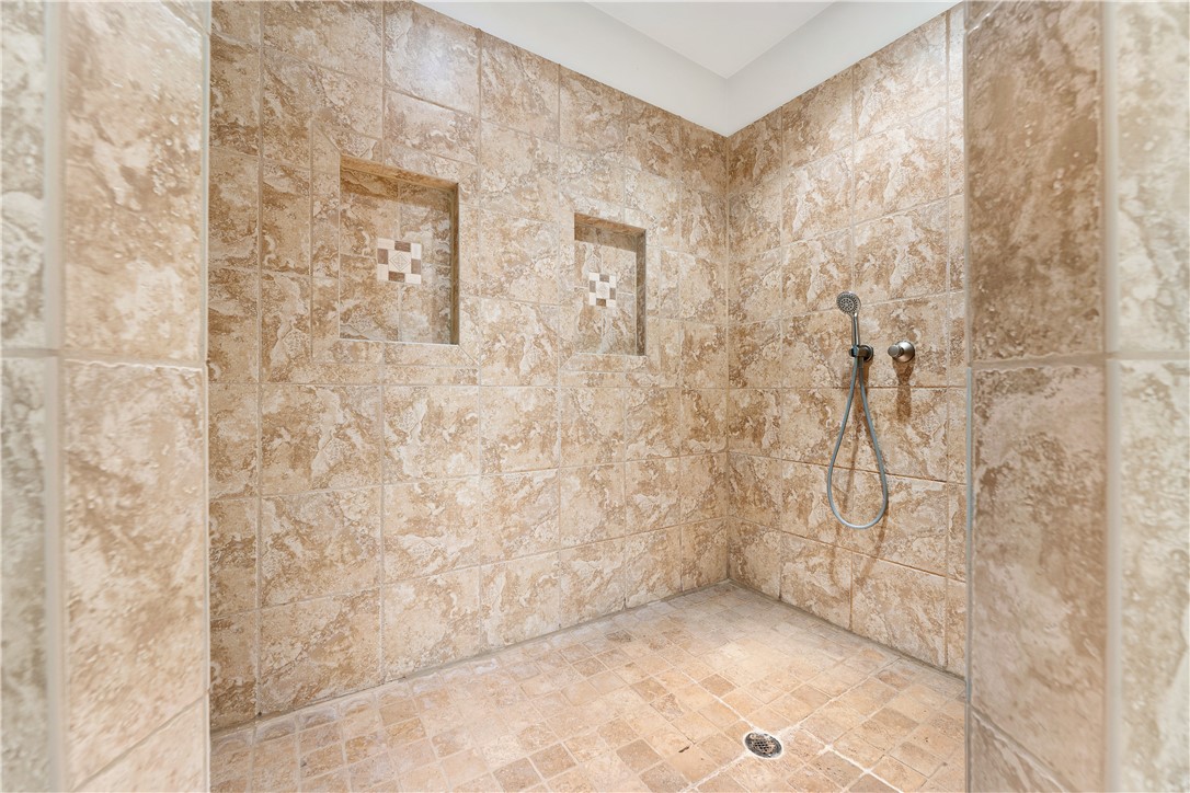 109 Limelight Drive Anderson, SC 29621 - Photo 12 of 34 This bathroom features a spacious shower with practical recessed niches and a handheld showerhead.
