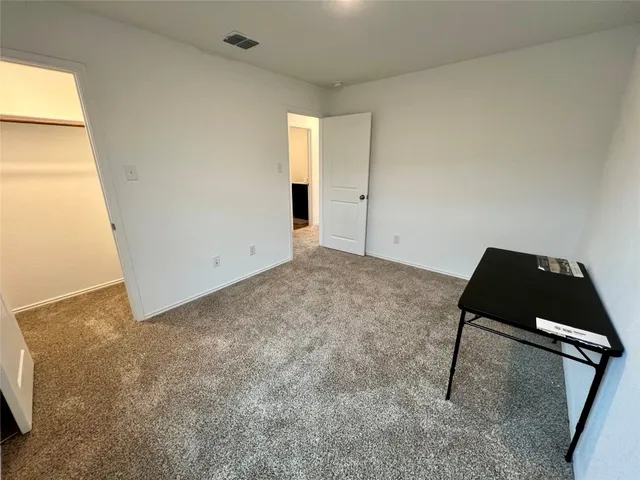 a view of an empty room and bathroom