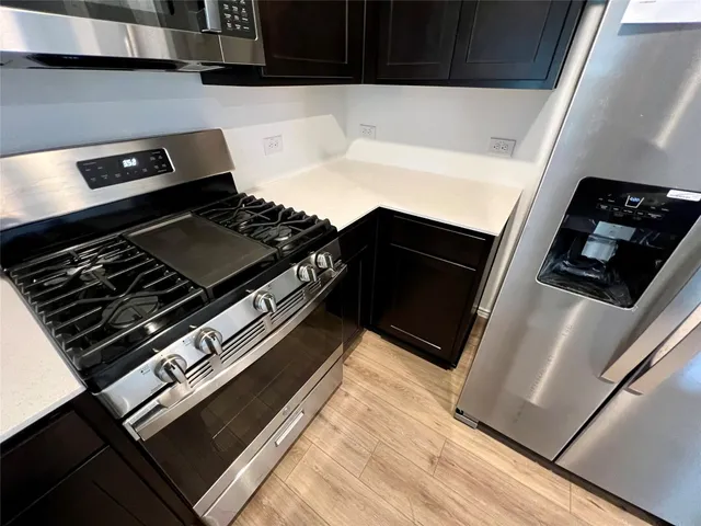 a stove top oven sitting inside of a kitchen