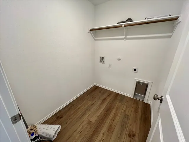 a view of a room with wooden floor and white walls