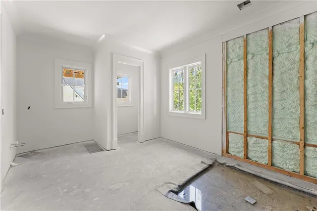 an empty room with windows and plants