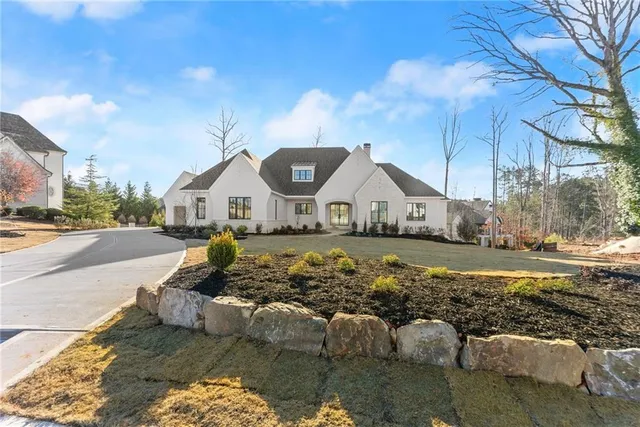 a view of house with outdoor space and swimming pool
