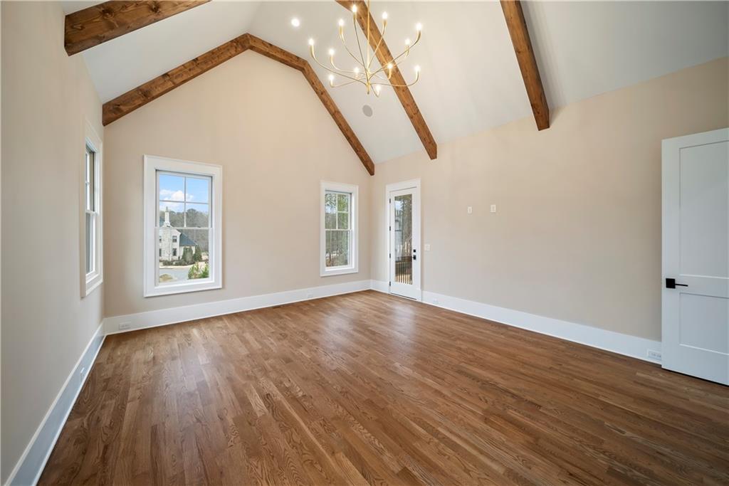 5071 Kings Cl Alpharetta, GA 30004 - Photo 45 of 53 a view of an empty room with wooden floor and a window