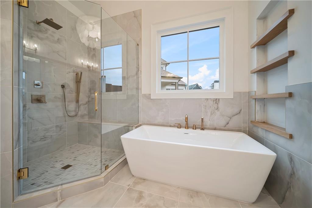 5071 Kings Cl Alpharetta, GA 30004 - Photo 51 of 53 a bathroom with a bathtub and shower