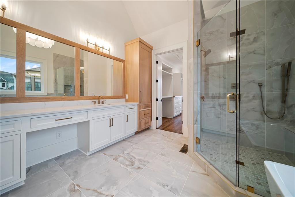 5071 Kings Cl Alpharetta, GA 30004 - Photo 53 of 53 a spacious bathroom with a double vanity sink a large mirror and a shower