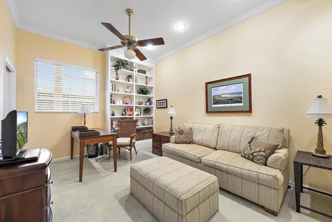 a living room with furniture a chandelier and a flat screen tv