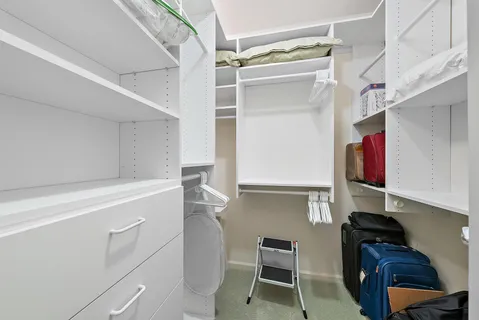 a room with a cabinets and a chair