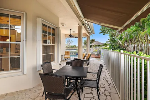 a view of an outside dining space with a table and chairs