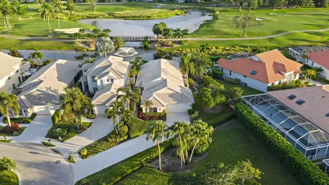 an aerial view of a residential houses with outdoor space and street view