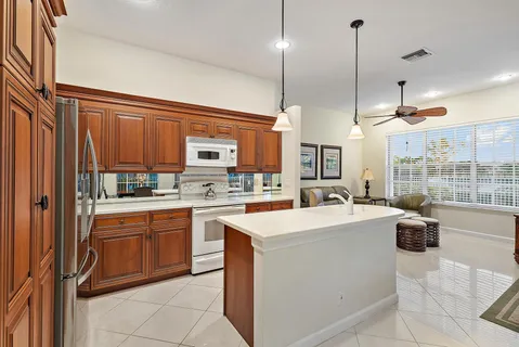 a kitchen with a sink a counter top space appliances and cabinets