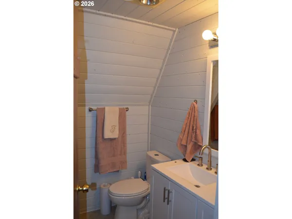 a bathroom with a sink toilet and mirror