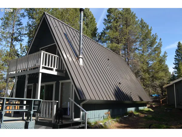 a view of a wooden house with a yard