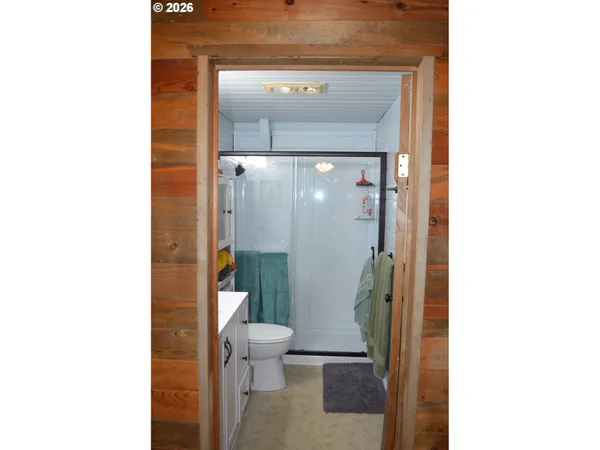 a bathroom with a toilet and a shower