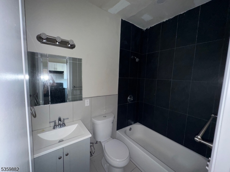 441 Summer Street Paterson, NJ 07501 - Photo 6 of 11 a bathroom with a sink toilet and shower