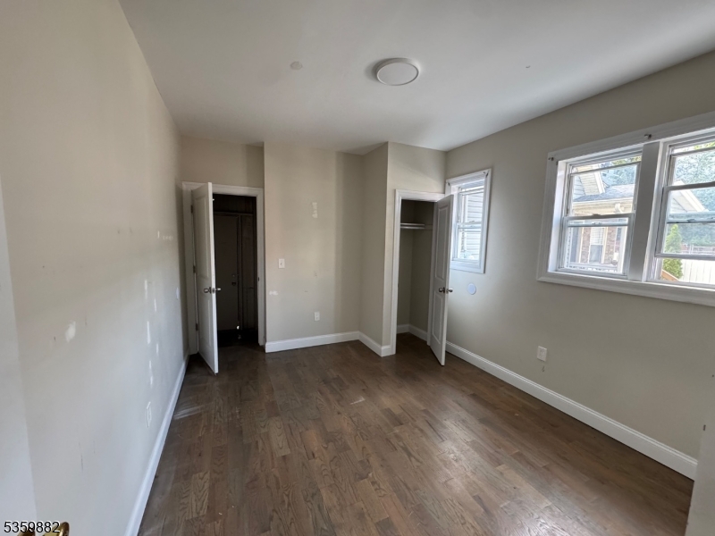 441 Summer Street Paterson, NJ 07501 - Photo 8 of 11 an empty room with wooden floor and windows