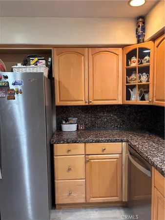 a kitchen with stainless steel appliances granite countertop a refrigerator and a stove