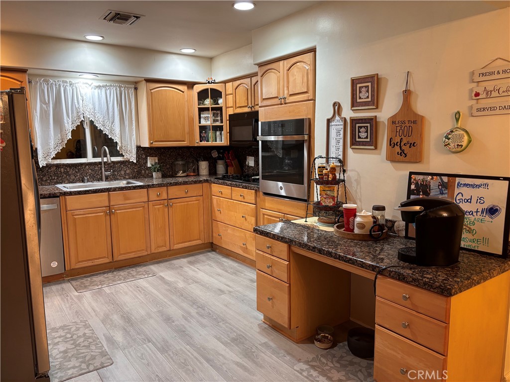 5604 Tower Road Riverside, CA 92506 - Photo 13 of 54 a kitchen with granite countertop a sink and cabinets