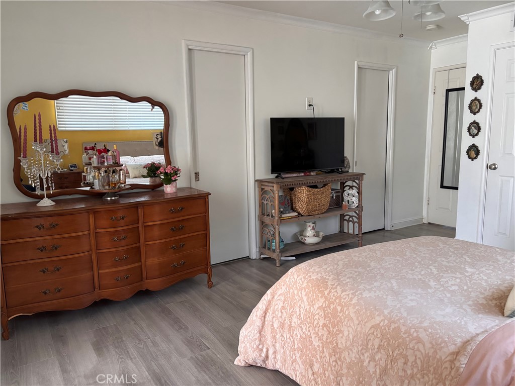 5604 Tower Road Riverside, CA 92506 - Photo 19 of 54 a bedroom with a bed and a flat tv screen on dresser