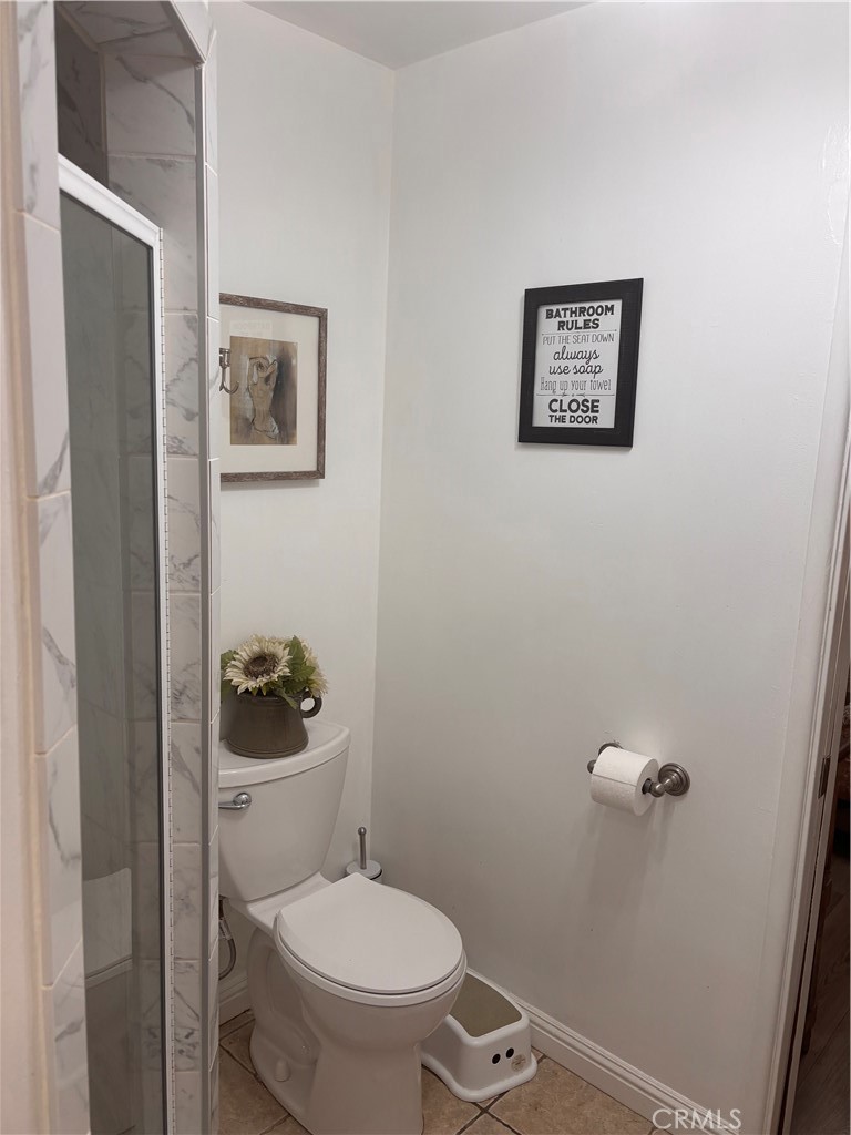 5604 Tower Road Riverside, CA 92506 - Photo 22 of 54 a white toilet sitting next to a bathroom sink