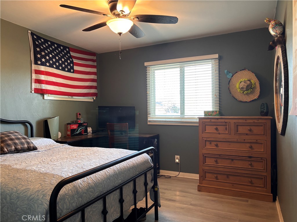 5604 Tower Road Riverside, CA 92506 - Photo 23 of 54 a bedroom with a bed and a chandelier