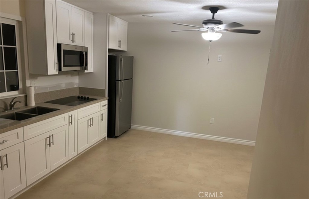 5604 Tower Road Riverside, CA 92506 - Photo 50 of 54 a kitchen with stainless steel appliances a sink and microwave