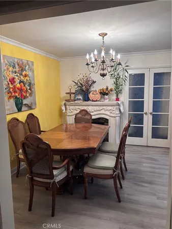 a view of a dining room with furniture and chandelier