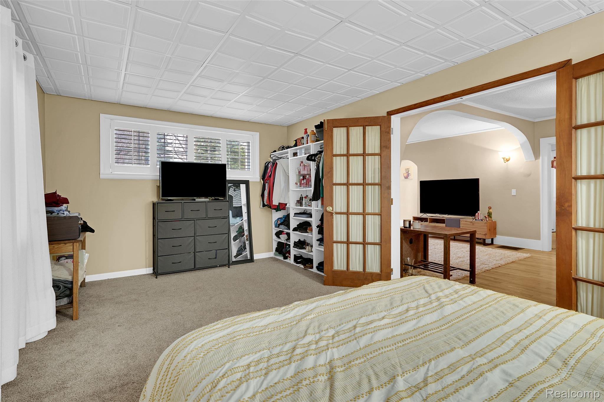 7972 3rd Street Forestville, MI 48434 - Photo 18 of 35 Bedroom featuring arched walkways and light colored carpet