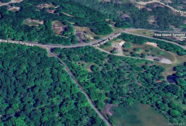 an aerial view of residential house with outdoor space and trees all around