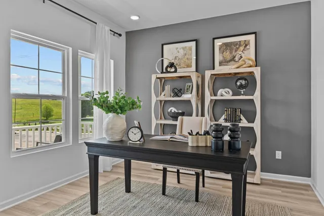 a view of a workspace with furniture and window