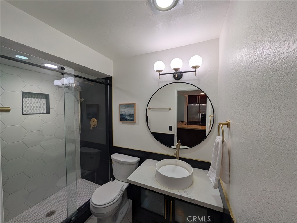 54 Oval Road, Unit 3 Irvine, CA 92604 - Photo 14 of 36 a bathroom with a toilet sink vanity granite and shower