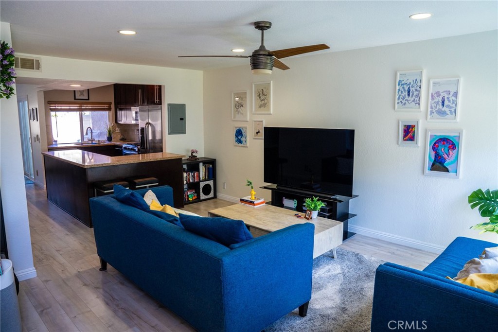 54 Oval Road, Unit 3 Irvine, CA 92604 - Photo 2 of 36 a living room with furniture and a flat screen tv