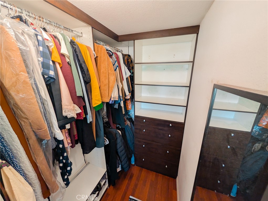 54 Oval Road, Unit 3 Irvine, CA 92604 - Photo 25 of 36 a view of walk in closet with clothes and shoes