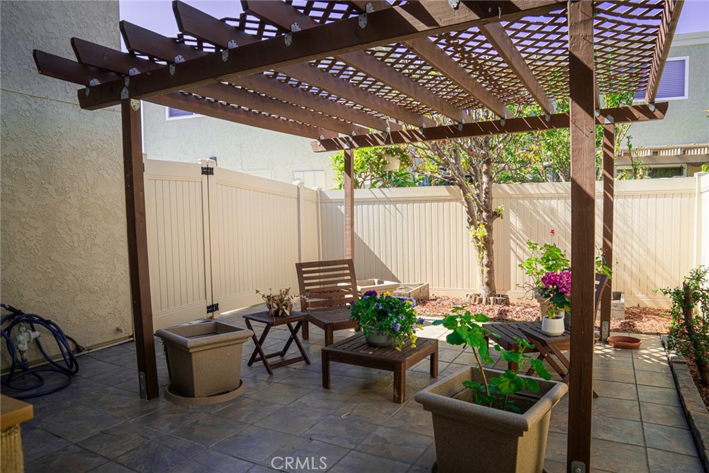 54 Oval Road, Unit 3 Irvine, CA 92604 - Photo 26 of 36 a view of a patio with table and chairs barbeque potted plants