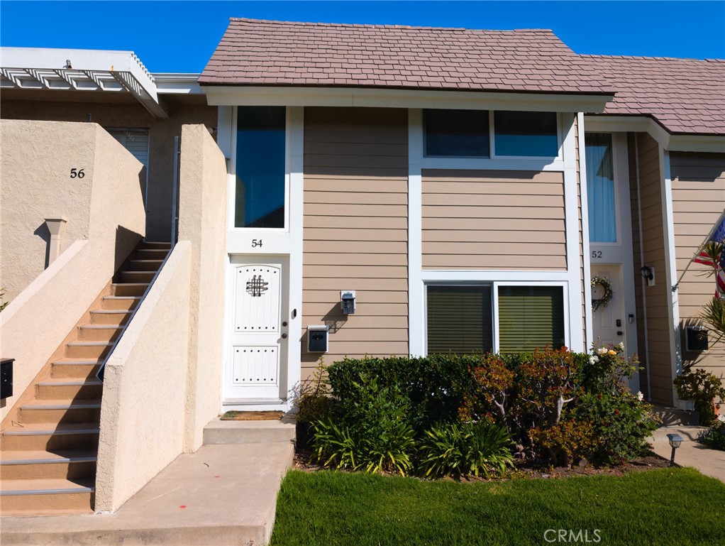 54 Oval Road, Unit 3 Irvine, CA 92604 - Photo 31 of 36 a front view of a house with a garden