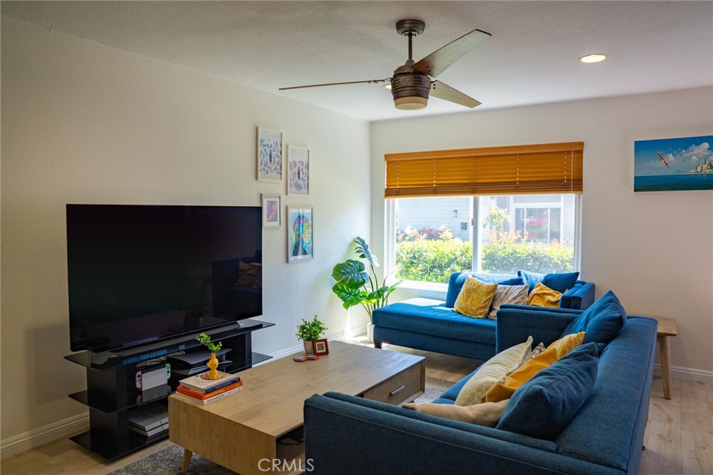54 Oval Road, Unit 3 Irvine, CA 92604 - Photo 5 of 36 a living room with furniture and a flat screen tv